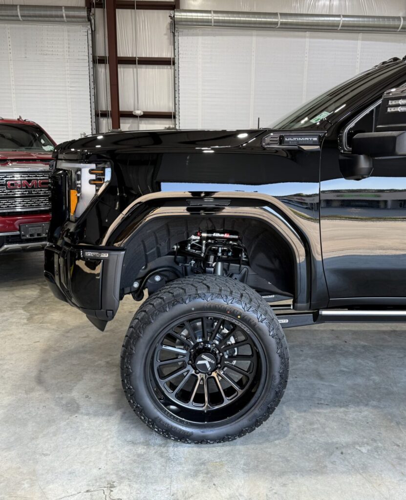 Lifted truck with a set of custom wheels and all terrain tires